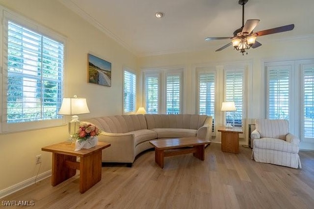 living room with light wood-type flooring, ceiling fan, and crown molding