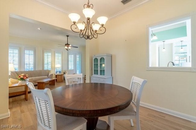 dining room featuring light hardwood / wood-style floors, ceiling fan with notable chandelier, and ornamental molding