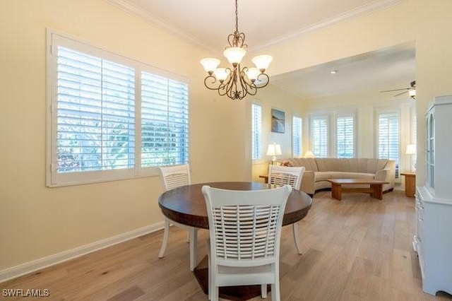 dining area featuring ornamental molding, a healthy amount of sunlight, and light hardwood / wood-style floors