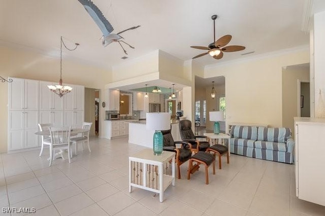 living room featuring ceiling fan with notable chandelier, light tile patterned flooring, and crown molding