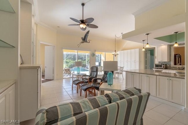 dining room featuring ceiling fan, light tile patterned flooring, and ornamental molding