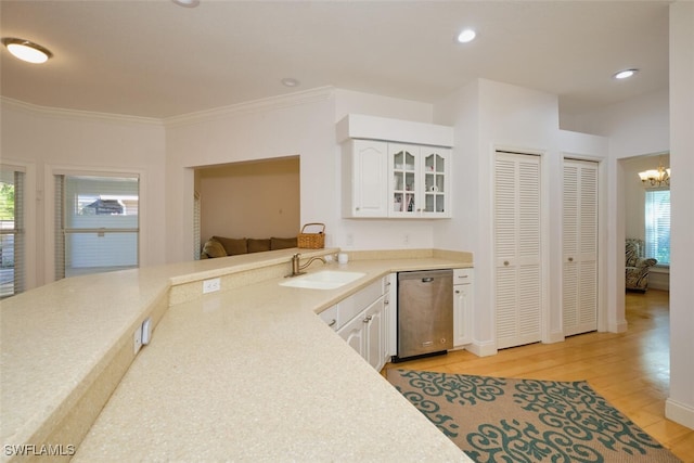 kitchen with stainless steel dishwasher, a healthy amount of sunlight, sink, light hardwood / wood-style floors, and white cabinetry