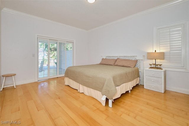 bedroom with access to exterior, hardwood / wood-style flooring, and ornamental molding