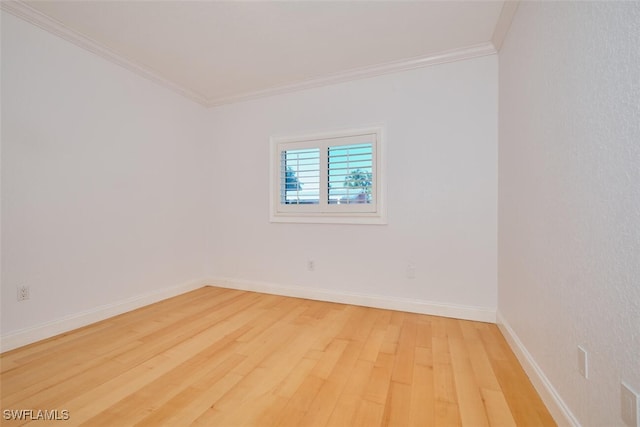 spare room with hardwood / wood-style floors and ornamental molding