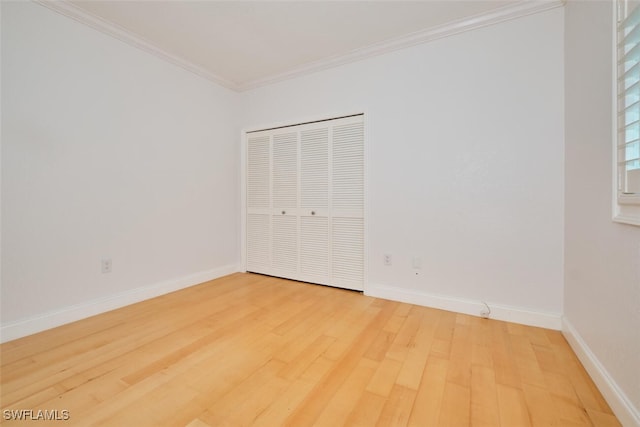 unfurnished bedroom with hardwood / wood-style floors and ornamental molding