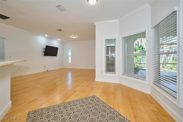 interior space featuring light wood-type flooring and crown molding