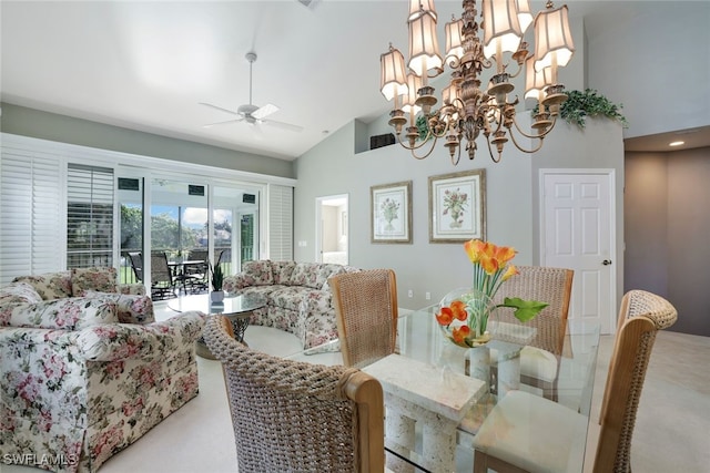 dining area featuring ceiling fan with notable chandelier, carpet floors, and high vaulted ceiling