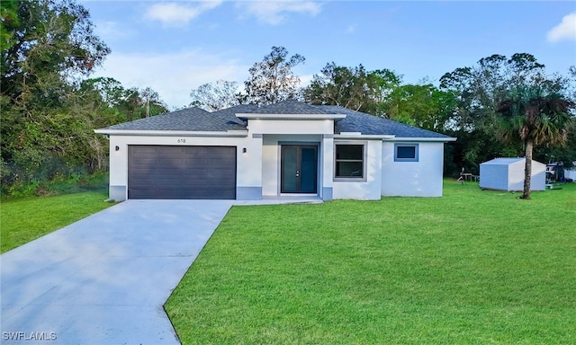 view of front of property with a front yard, a shed, and a garage