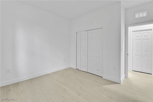 unfurnished bedroom featuring light wood-type flooring