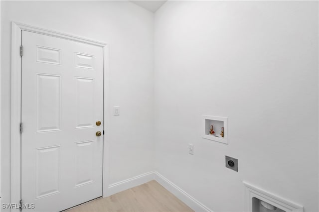 clothes washing area featuring washer hookup, light wood-type flooring, and electric dryer hookup