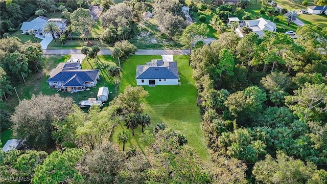 birds eye view of property with a forest view