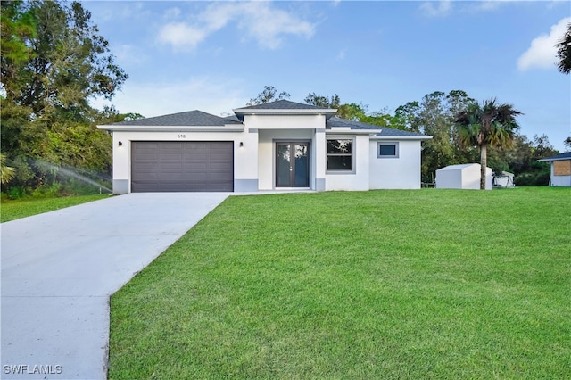 view of front of house with a front yard and a garage