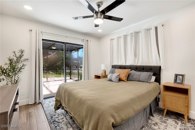 bedroom featuring access to outside, hardwood / wood-style flooring, and ceiling fan