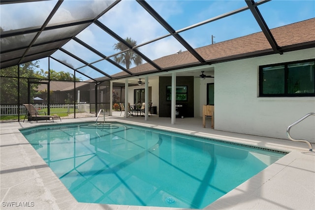 view of swimming pool featuring a lanai, ceiling fan, and a patio area