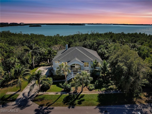 aerial view at dusk with a water view