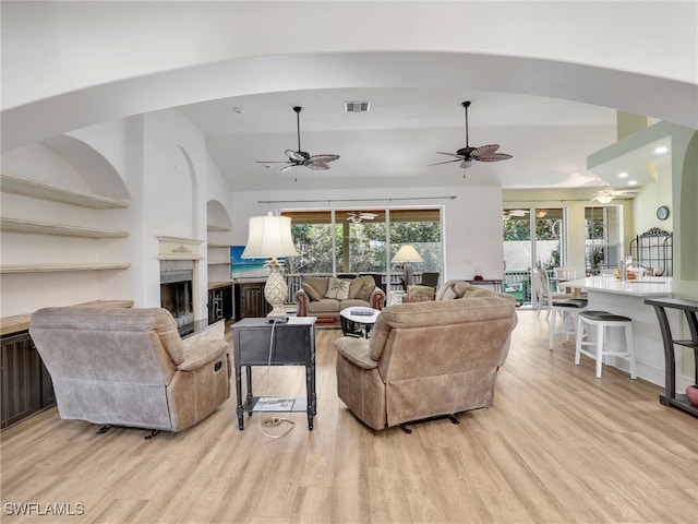 living room featuring light wood-type flooring and vaulted ceiling