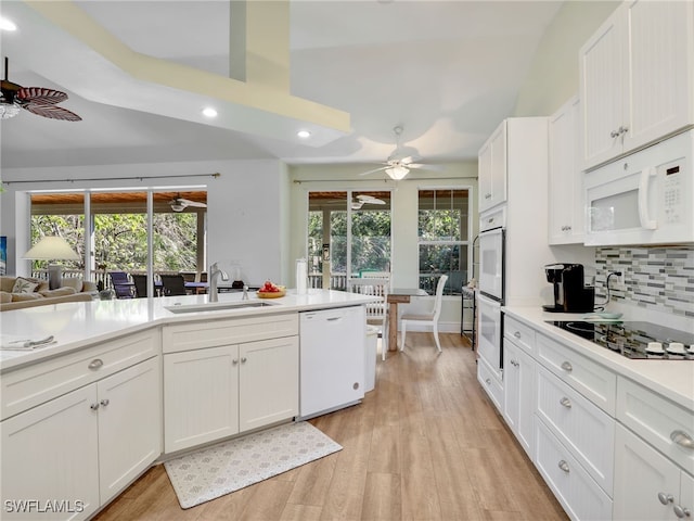 kitchen featuring white appliances, white cabinetry, and sink