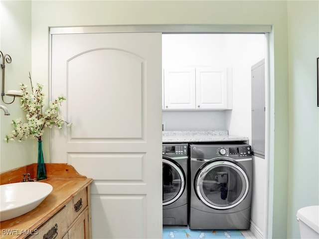 washroom with washer and dryer and sink