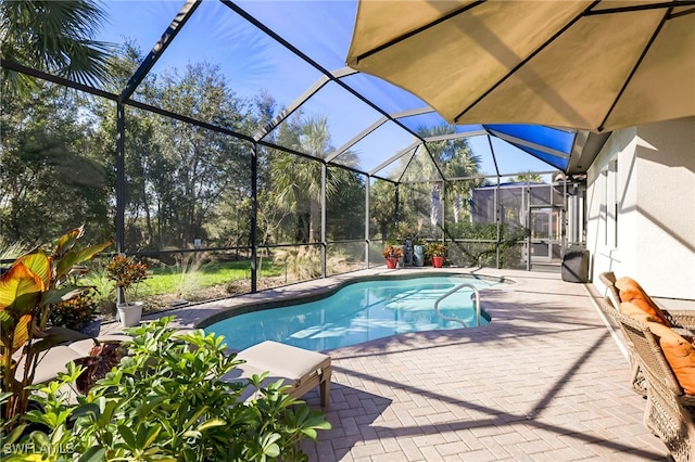 view of pool featuring a patio and glass enclosure