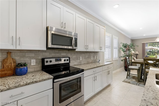 kitchen with plenty of natural light, white cabinetry, and appliances with stainless steel finishes