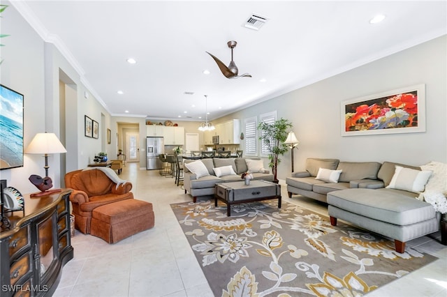 tiled living room featuring crown molding and a notable chandelier