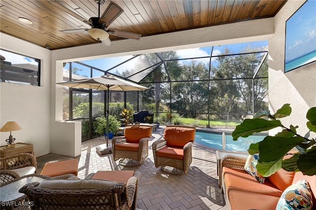 sunroom with ceiling fan, wooden ceiling, and a swimming pool