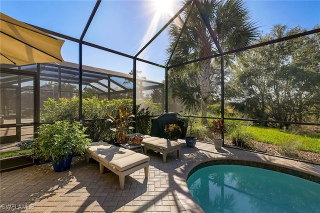 view of swimming pool with a lanai, a grill, and a patio