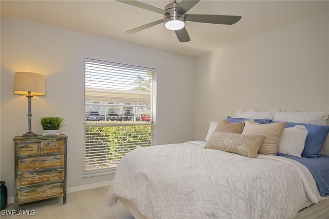 bedroom with light colored carpet, multiple windows, and ceiling fan