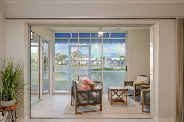 sunroom featuring a water view and a wealth of natural light