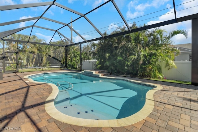 view of pool with a patio area and a lanai