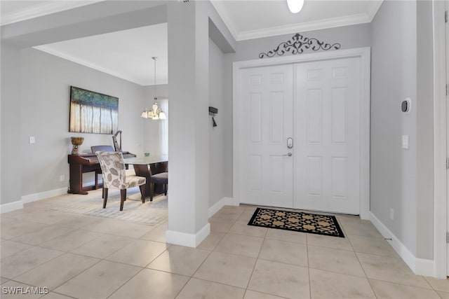 entrance foyer with light tile patterned floors, crown molding, and a notable chandelier