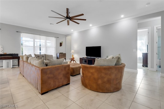 tiled living room featuring ceiling fan and crown molding