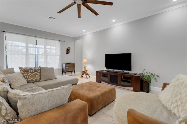 living room featuring light tile patterned floors, ceiling fan, and crown molding