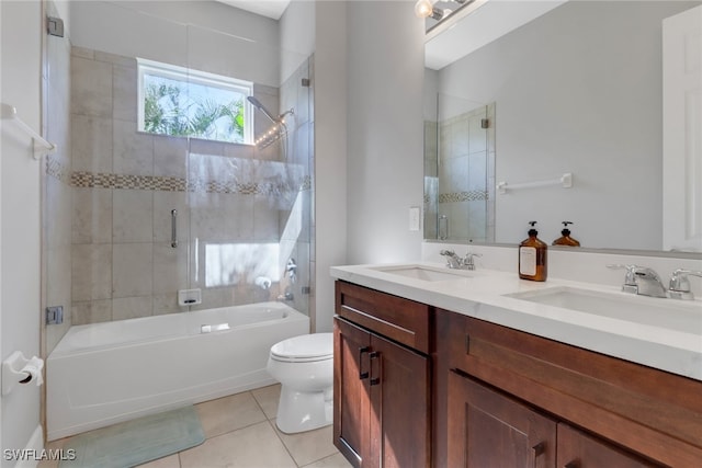 full bathroom with tile patterned flooring, vanity, toilet, and enclosed tub / shower combo