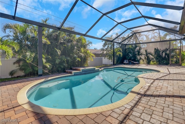 view of swimming pool with a lanai and a patio