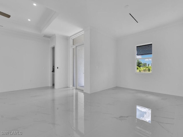 spare room featuring ceiling fan and ornamental molding