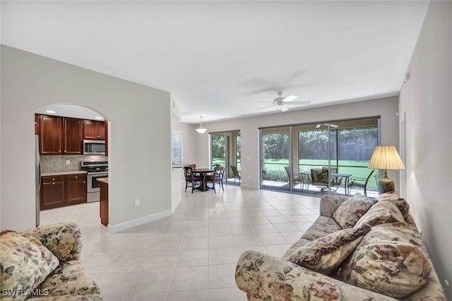 living room featuring ceiling fan and light tile patterned flooring