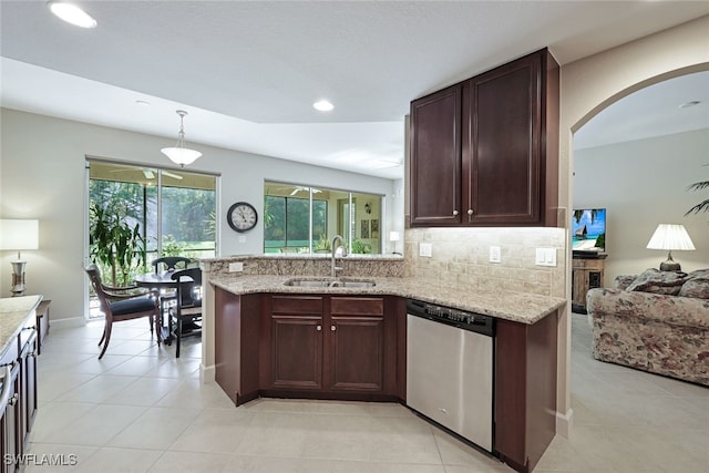 kitchen with dishwasher, tasteful backsplash, light stone counters, and sink