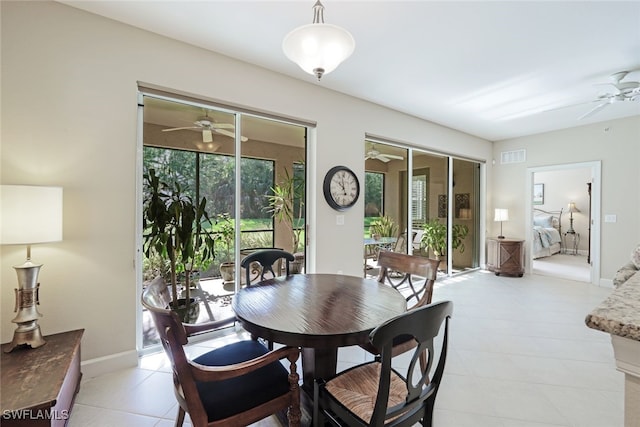 dining space featuring ceiling fan and light tile patterned floors