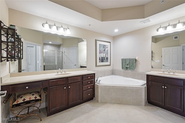 bathroom featuring tile patterned flooring, vanity, and plus walk in shower