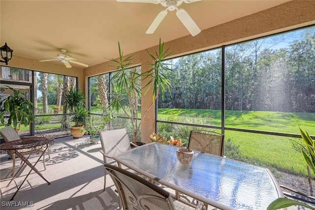 unfurnished sunroom with ceiling fan