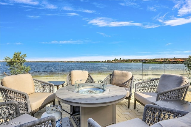 view of patio with a water view and a view of the beach