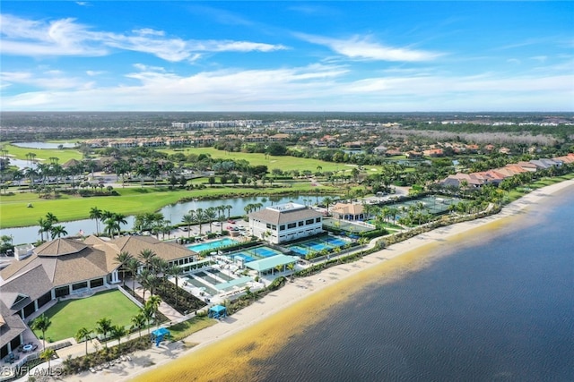 birds eye view of property with a water view and a beach view