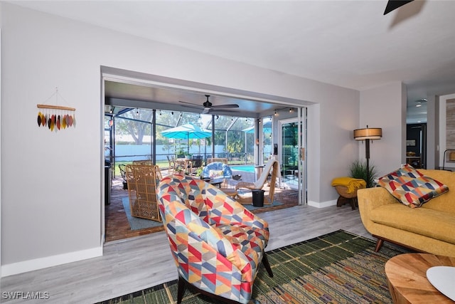 living room featuring ceiling fan and wood-type flooring