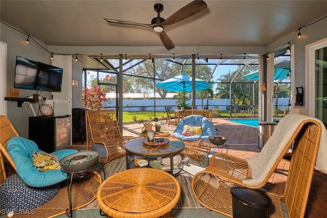 sunroom featuring a pool and ceiling fan