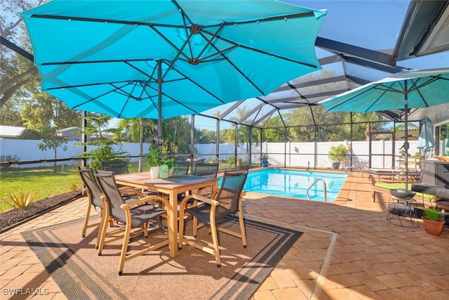 view of pool featuring glass enclosure and a patio area