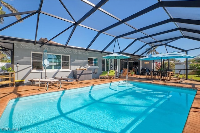 view of swimming pool with a lanai and a patio area