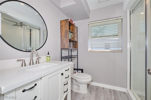 bathroom with toilet, vanity, wood-type flooring, and walk in shower