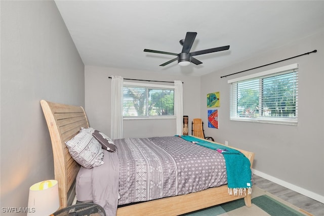 bedroom with hardwood / wood-style flooring and ceiling fan