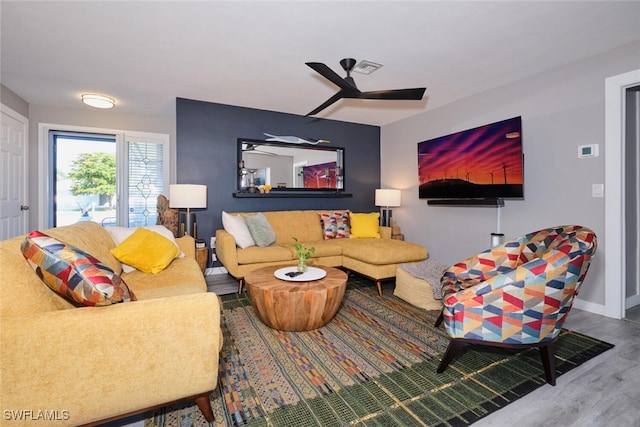 living room with hardwood / wood-style floors and ceiling fan